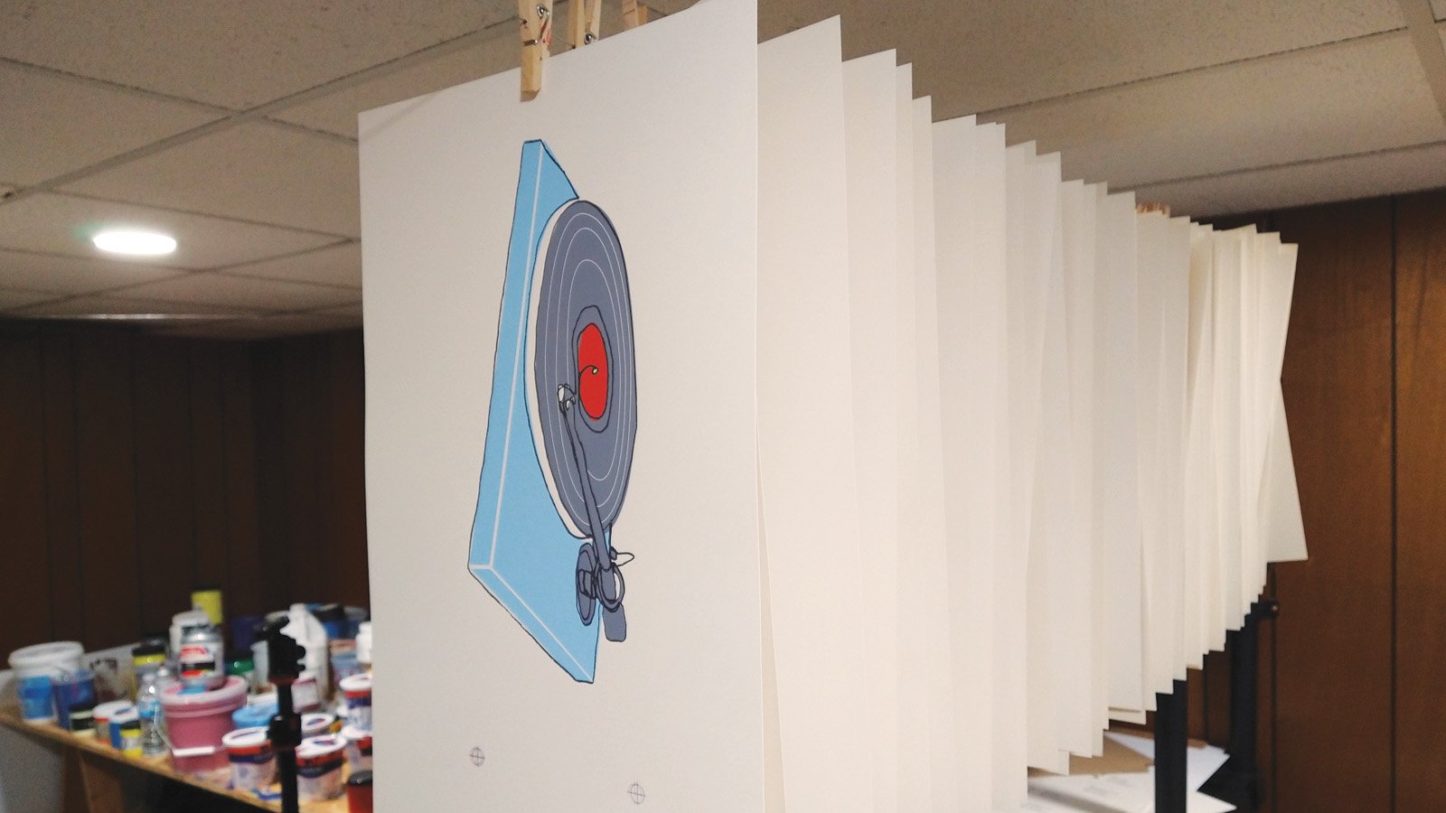 Copies of the Records Are Ritual print hanging from the drying line in the print studio.